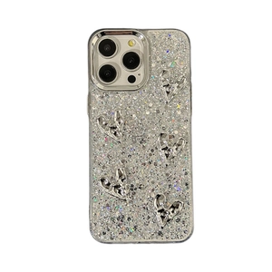 Sparkly silver glitter iPhone case featuring 3D metallic hearts in a trendy Y2K aesthetic