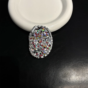 Macro view of sequin-filled oval phone grip with glitter and silver metallic frame