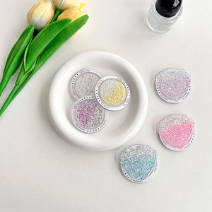 Close-up of glitter heart and round Magsafe phone grips with Gift For You engraving