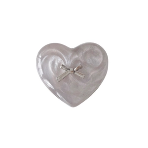 Purple heart phone socket with marble texture and silver metallic bowknot on white background