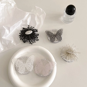 Creative sunflower and lace butterfly phone grip holders in elegant lifestyle setting