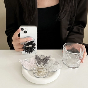 Detailed view of handmade lace butterfly phone grip stand in various elegant textures