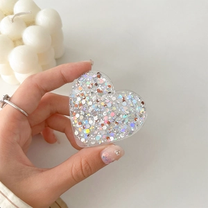 Detail of heart-shaped phone socket with glitter sequins and colorful resin finish