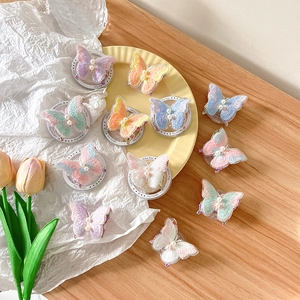 Exquisite butterfly embroidery hair clips with pearls on elegant desktop layout