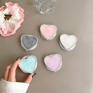 Detail of colorful marble heart phone grips with rhinestone edges and telescopic bases