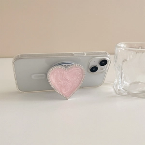 Pink heart magnetic phone socket with marble texture and rhinestone trim on white phone