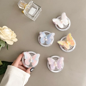 Detail of 5-piece butterfly phone grips with embroidery textures and pearl accents