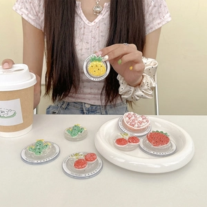 Detailed view of handmade beaded strawberry and pineapple phone griptok accessories