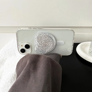 Close-up of silver glitter heart phone socket on clear case with Gift For You text