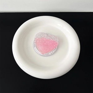Detail of heart-shaped glitter phone grip with pink and silver gradient sparkle effect