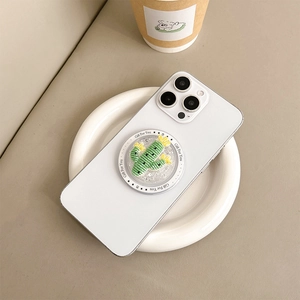Macro shot of 3D knit-style cactus phone grip with glitter on a white iPhone case