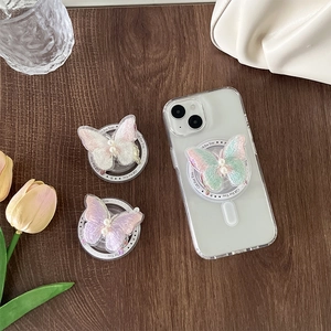 Creative embroidered butterfly phone socket with pearl accent on a clear magnetic base