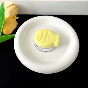 Close-up of a yellow Taiyaki shaped fish phone grip with Gift For You base detail