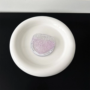 Detail of heart-shaped glitter phone grip with purple gradient finish and base engraving