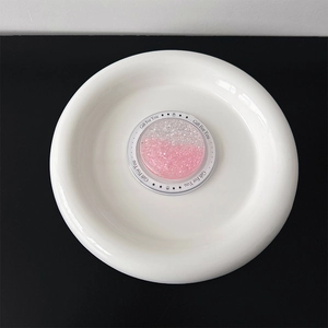 Close-up of pink glitter heart phone grip with Gift For You text on a white tray