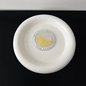 Detail of round glitter heart phone socket on a Gift For You card in a white ceramic dish
