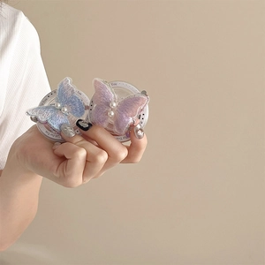 Detailed view of embroidered butterfly phone grip with pearl and Gift For You text