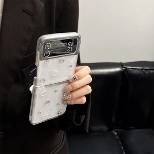 Close-up of glitter phone case for Z Flip with pearls, rhinestones, and bow decor
