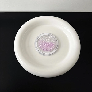 Detail of glitter gradient phone grip with Gift For You text on a white ceramic plate