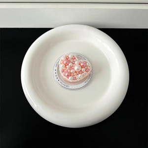 Macro shot of heart-shaped phone grip with pink and white imitation pearls on a gift card