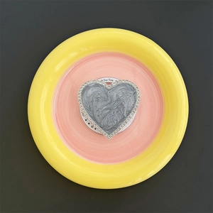Detail of heart magnetic phone grip with marble pattern and rhinestone trim on display tray