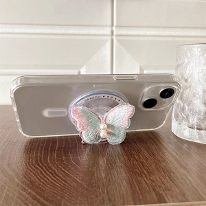 Detail of embroidered pink and green butterfly phone grip with white pearls on wood surface