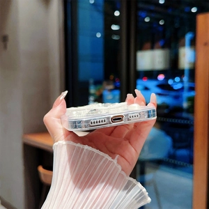 Gros plan des découpes précises et des strass perlés sur la coque iPhone transparente