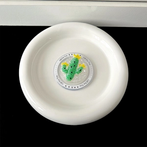 Close-up of green cactus collapsible phone grip with yellow flowers on a Gift For You base