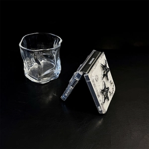 Detailed view of Samsung Z Flip case with silver glitter star patterns on black leather