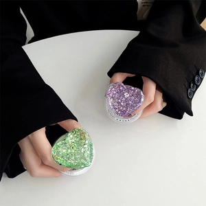 Detail of glitter heart phone grips in green and purple colors with Gift For You text