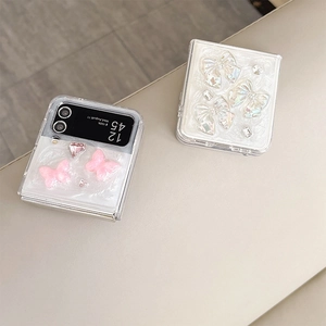 Detailed view of pearl finish phone cases with 3D bows and rhinestones for Galaxy Z Flip