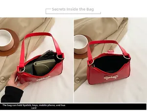 Detail showing the internal capacity and main compartment of a red glossy hobo bag