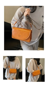 Detail of a brown PU leather crossbody bag with white stitching and ethnic strap