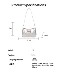 Silver PU mini shoulder bag with golden bow detailing showing size 21x13x6 cm
