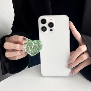 Detail of green sequin heart phone grip holder with sparkling glitter finish on back