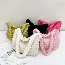 Detail view of mini underarm bags featuring bubble texture in various candy colors