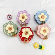 Flat lay of candy-colored mini flower shoulder bags in five vibrant pastel colors