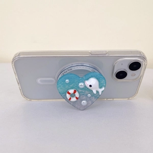 Ocean blue heart-shaped phone grip tok with dolphin and pearl accents on a clear case