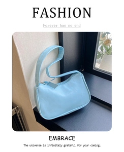 Close-up of light blue PU leather underarm bag with zipper and wide handle
