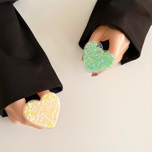 Close-up of heart-shaped glitter phone sockets in green and pink sequins finish