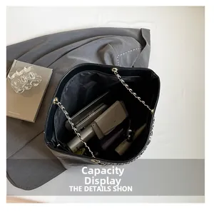 Internal view of large black tote bag showing capacity for laptop and essentials