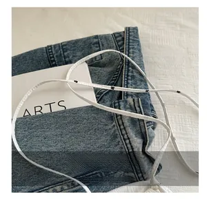 Detail shot of the comfortable patterned shoulder strap on a denim bucket bag fabric