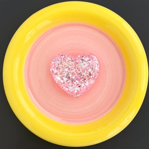 Macro detail of a heart-shaped resin phone socket with pink and silver glitters