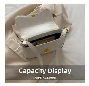 Detailed view of white PU leather flap bag interior showing capacity for phone and wallet