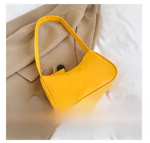 Mini yellow hobo bag size comparison with a smartphone showing compact dimensions