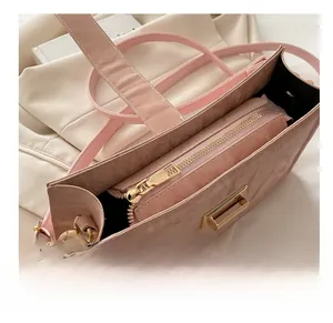 Detail view of pink marble pattern bag showing golden zipper and internal compartment