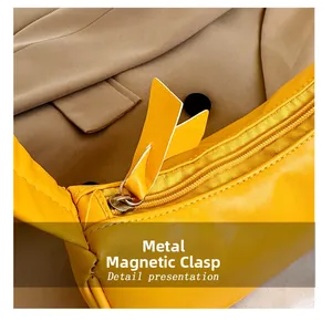 Detail shot of yellow leather mini bag featuring high-quality zipper and magnetic closure