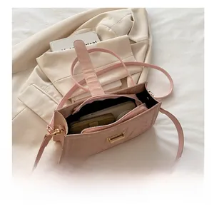 Detail view of the spacious pink leather crossbody bag interior showing storage capacity
