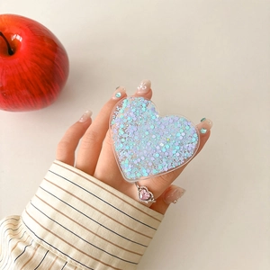 Detail of heart-shaped glitter phone grip with blue and purple sequins in clear acrylic