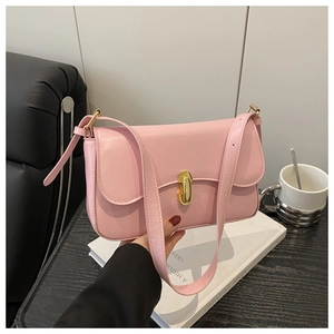 Detail of pink faux leather handbag with elegant golden oval metal clasp closure
